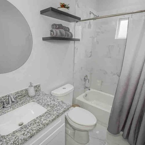 Clean bathroom w/ makeup towels & hair dryer ready for your morning routine.