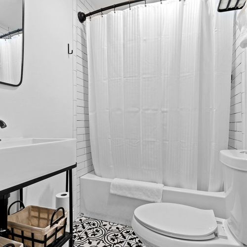 Clean full bathroom attached to the fifth bedroom — convenient & private.