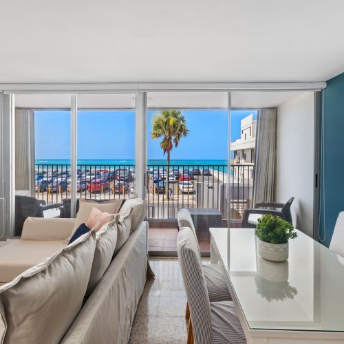 Large windows offering panoramic views of the Caribbean Sea and the historic streets below.