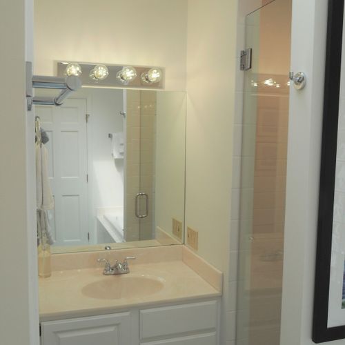 Bathroom #2 (main floor):  this is a private en suite bathroom for the master bedroom (bedroom #1). Features 2 sinks, a large bathtub, and separate shower and toilet facilities.