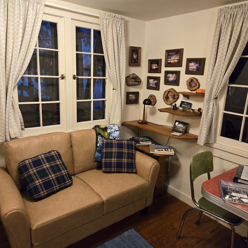 Living room:  the cabin has a cute little living room with a loveseat, dining table, and streaming television.
