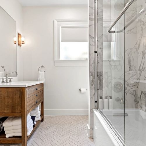 Bright bathroom w/ walk-in shower & clean, modern finishes.