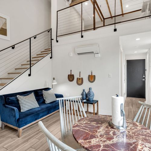 Stylish open-concept loft with modern decor, cozy seating, and vibrant New Orleans charm.