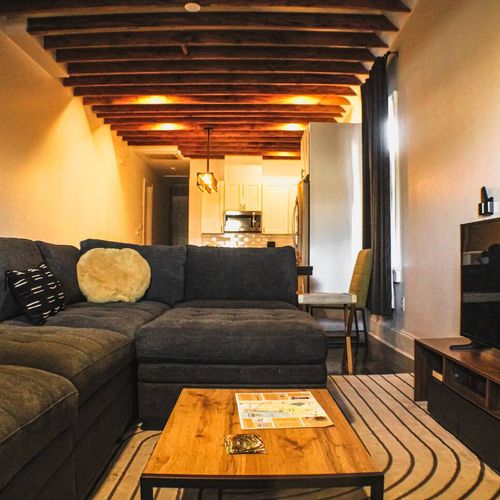 Warm, inviting living space w/ rich wood tones & cozy seating for the whole group.