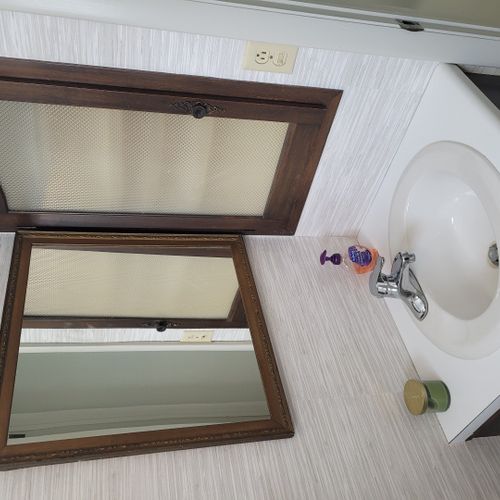 Bathroom #2:  cute little half-bathroom with toilet, sink, vanity, and mirror located near the rear door out to the deck.