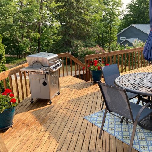 Exterior:  the large deck, featuring a propane grill and outdoor dining furniture.