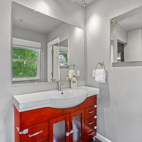 The master en-suite full bathroom has a separate vanity and sink area from the shower/tub combo and toilet.