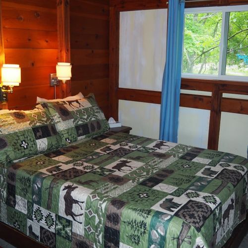 Bedroom #1:  features a full-size bed, chair, dresser, closet, and mirror.