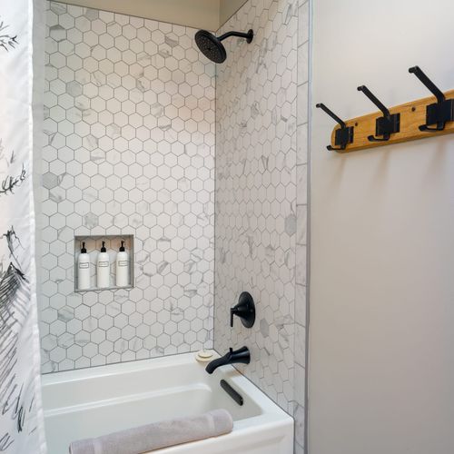 Bathroom with marble sink and a hot tub shower mix
