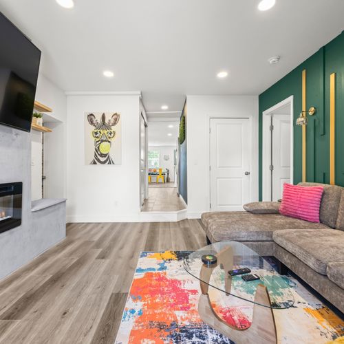 Spacious living area with fireplace, smart tv, and plush sectional.