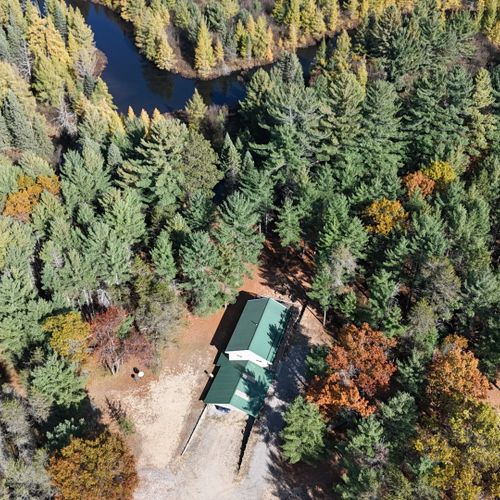 Exterior:  the lodge, detached garage, and goose creek from the air.