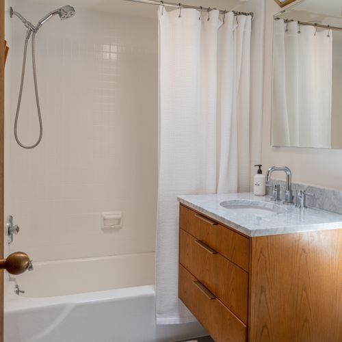 The skylight allows the sun and stars to shine in this newly renovated bathroom.