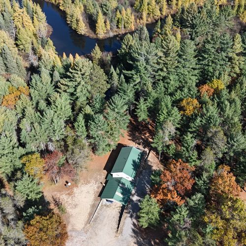 Exterior:  the lodge, detached garage, and goose creek from the air.