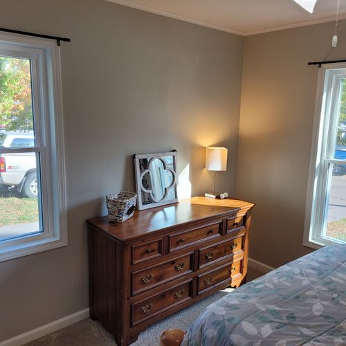 Bedroom #1:  features a queen-size bed, ceiling fan, nightstand, lamp, closet, and dresser.