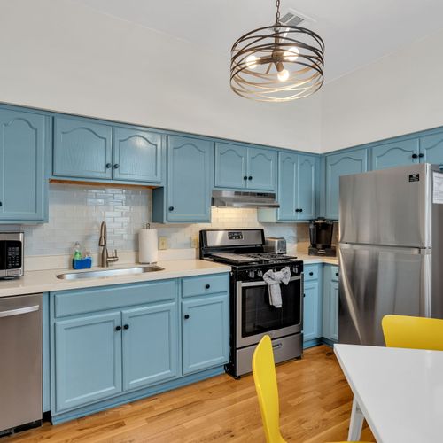 Cheerful blue kitchen w/ stainless appliances & plenty of counter space to cook up a meal.