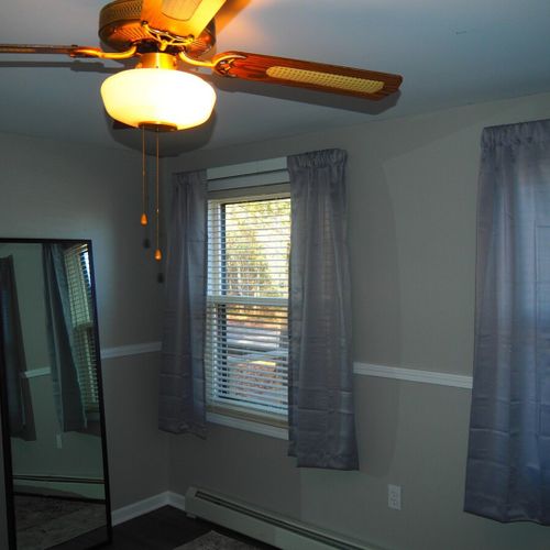 Bedroom #1 (main floor):  features a queen-size bed, dresser, nightstand, mirror, closet, ceiling fan, and a very nice lake view!