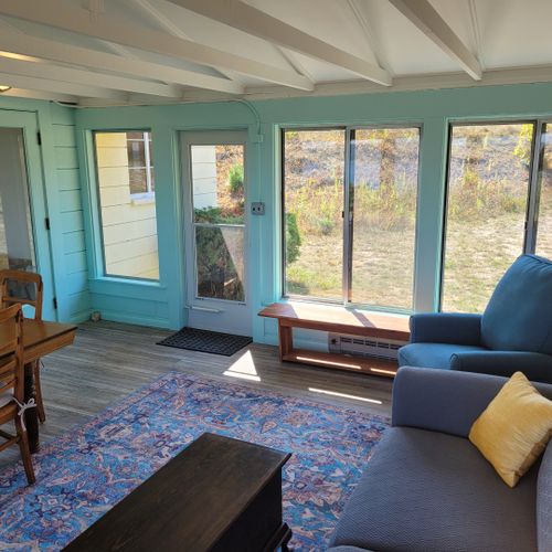 Sunroom:  the cottage has a very fun and family-friendly sunroom with a dining / game table, sofa, comfy chair, and a great view of crystal lake