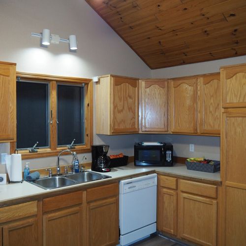 Kitchen:  full kitchen with all modern appliances including a microwave, toaster, coffee maker, and dishwasher. Also includes lots of cabinet space and a good supply of cooking and dining utensils.