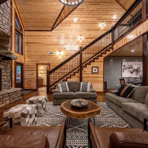 Floor to ceiling fireplace, love seat & oversized couch add comfort to the room
