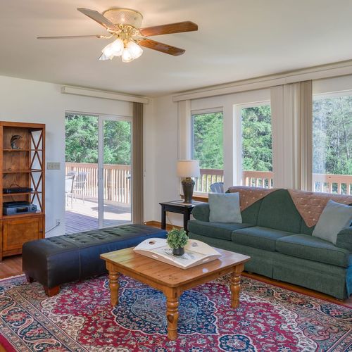 The living room has a beautiful deck for outdoor dining.