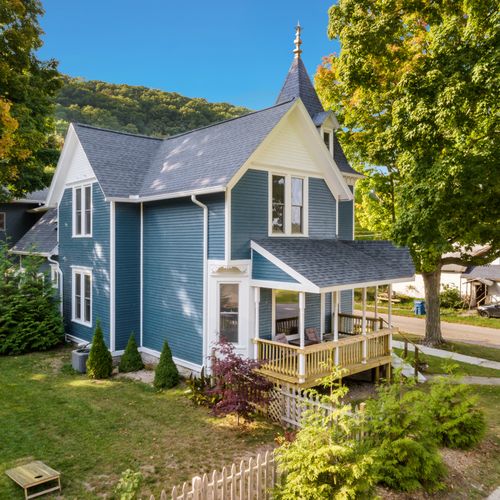 OVERVIEW:  The front and east isde of the of the house (including fenced-in backyard) in summer.