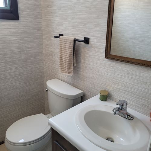 Bathroom #2:  cute little half-bathroom with toilet, sink, vanity, and mirror located near the rear door out to the deck.