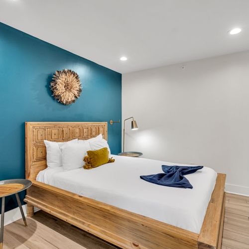 This spacious room features a king-size bed, fresh linens, and minimalist decor, creating a relaxing vibe after a day in NOLA.