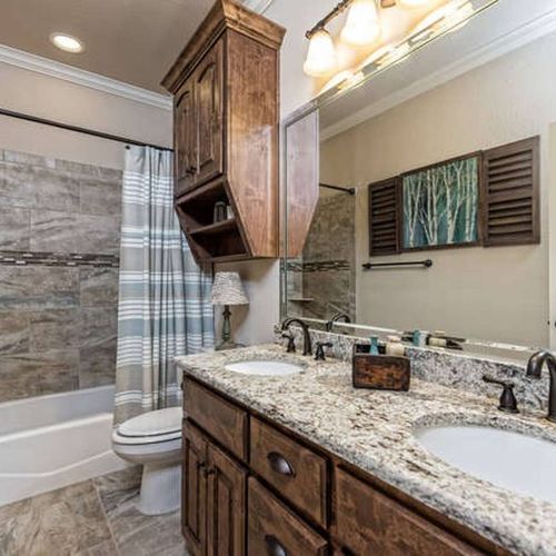 Main Bathroom Double vanities, granite counters ensure every guest has the space and style they need to start and end the day refreshed.