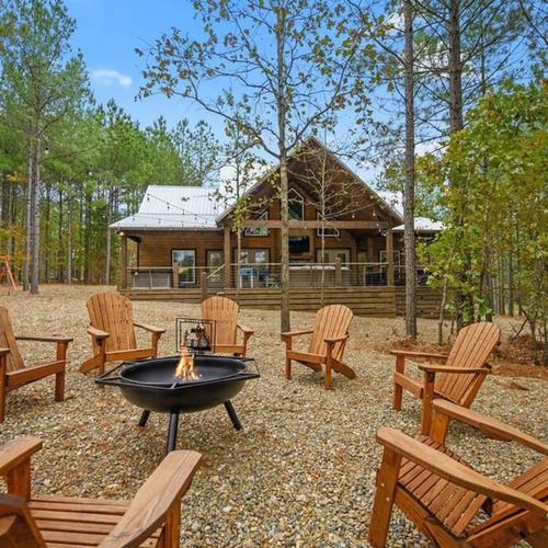 Fire pir with Adirondack chairs surrounding.
