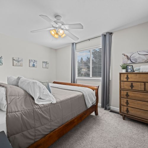 Comfortable bedroom with a queen size bed, storage, soft light, and peaceful atmosphere