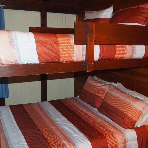 Bedroom #2:  features a full-on-full bunk bed, dresser, closet, and chair.