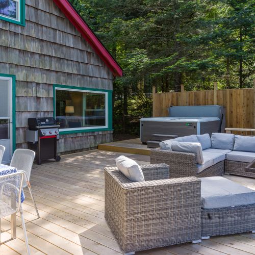 Walk out the living room to an expansive deck with an outdoor living room and spa.