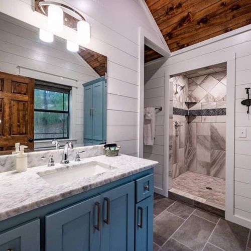 Equipped with a private bathroom featuring a walk-in shower.
