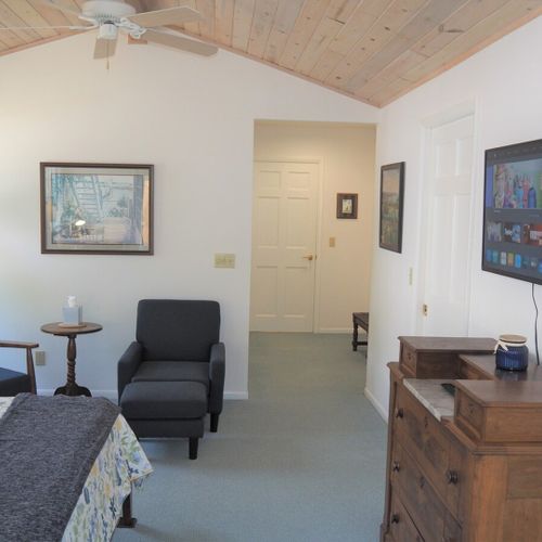 Bedroom #1 (main floor):  the large walk-in closet is to the left through the doorway. The door to the private laundry room is shown to the left of the television. The door to the private en suite bathroom is to the right of the television.