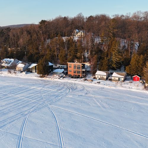 EXTERIOR:  Aerial view of the home from up above Crystal Lake in the winter