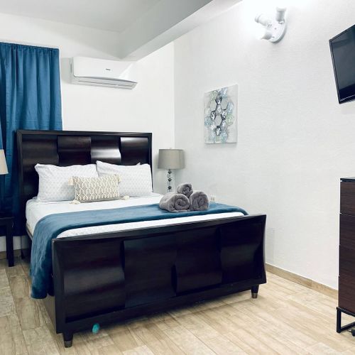 Experience restful nights in our comfortable main bedroom, boasting a plush queen-size bed and a powerful air conditioner to keep you cool and relaxed.