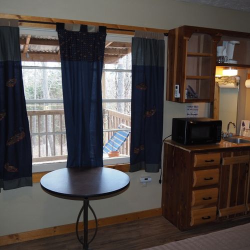 Main room:  includes a full-size bed, table, and small sink / kitchenette.