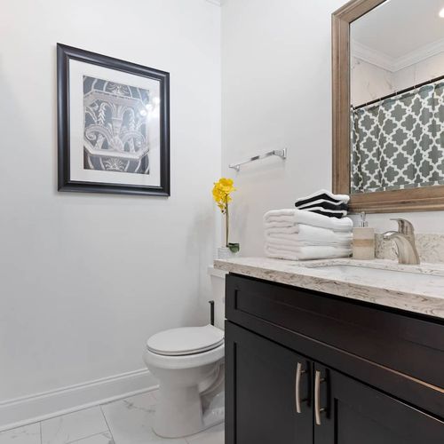 Clean, bright bathroom w/ sink & all the essentials to freshen up.