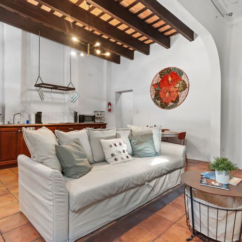 The spacious living room offers a cozy couch and a stylish coffee table, creating the perfect setting for relaxing or hosting gatherings.