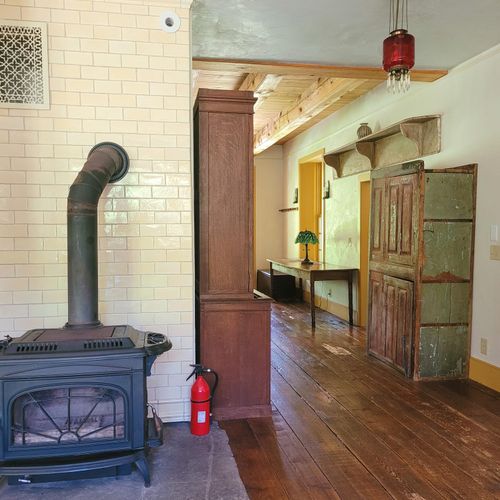 Wood stove in the kitchen leading into living room is currently non-operational