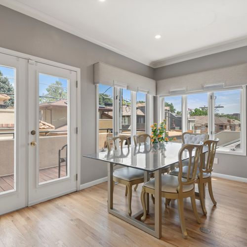 Sun-filled dining area with comfy chairs and an inviting setup for shared meals.