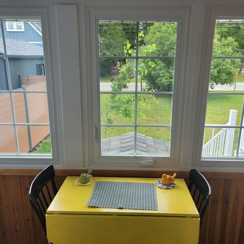 BACK PORCH:  The cottage has a very cute fully-enclosed back porch with a breakfast table.