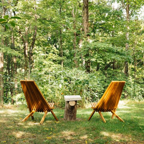 The outdoor space makes for a delightful oasis among the trees.