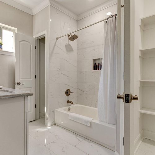 Clean, bright master en suite w/ tub & shower — everything you need.