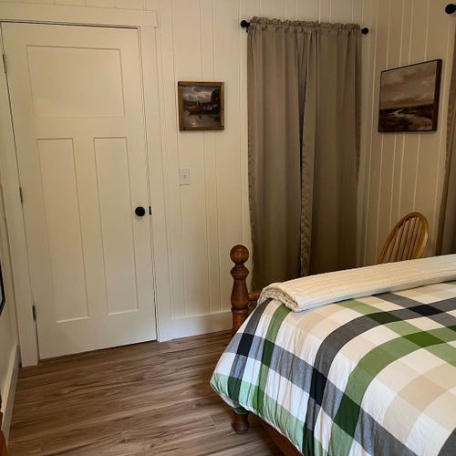 Bedroom #1:  features a queen-size bed, dresser, and chair.