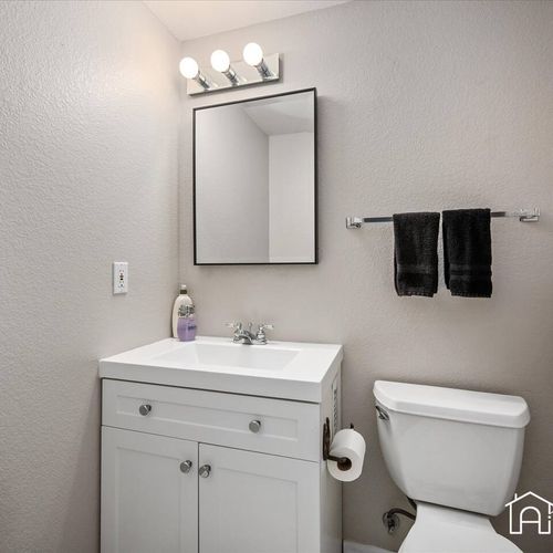 - fresh and simple bathroom with modern white vanity, black towel set, and bright lighting
- great for quick freshen ups or evening routines in a clean, stylish space
- conveniently located for easy access from nearby rooms