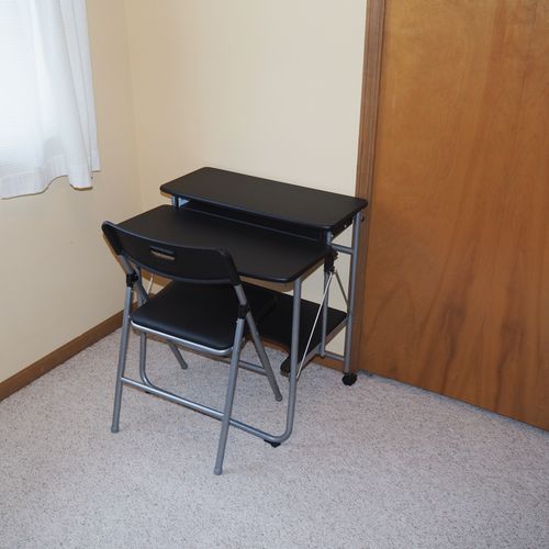 Office (main floor):  features a comfy chair, piano, dresser, and desk with chair.