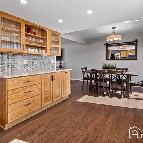 - view from the kitchen into the dining area with sideboard and open shelving cabinetry
- perfect for entertaining or serving up drinks, snacks, or buffet style meals
- hardwood floors tie the spaces together with natural warmth and flow