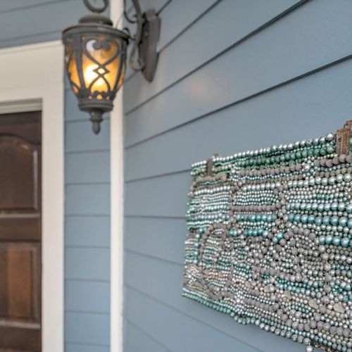 Welcoming porch with lantern lighting and local flair.