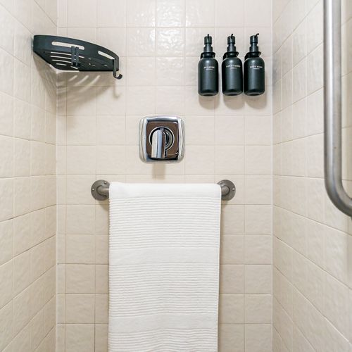 Shower room located inside train car.